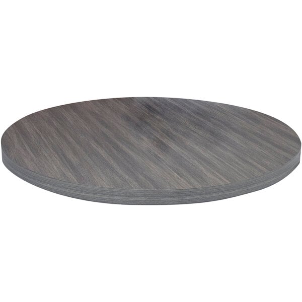 An American Tables & Seating round light gray faux wood laminate table top on a table.