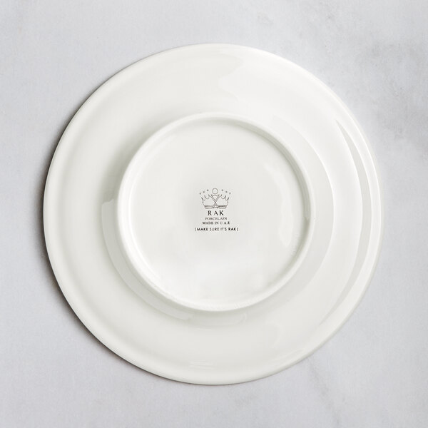 A white RAK Porcelain flat plate with an embossed circular design.