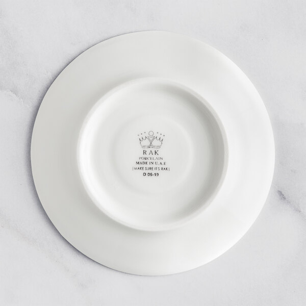 A RAK Porcelain ivory saucer with an embossed crown on it.