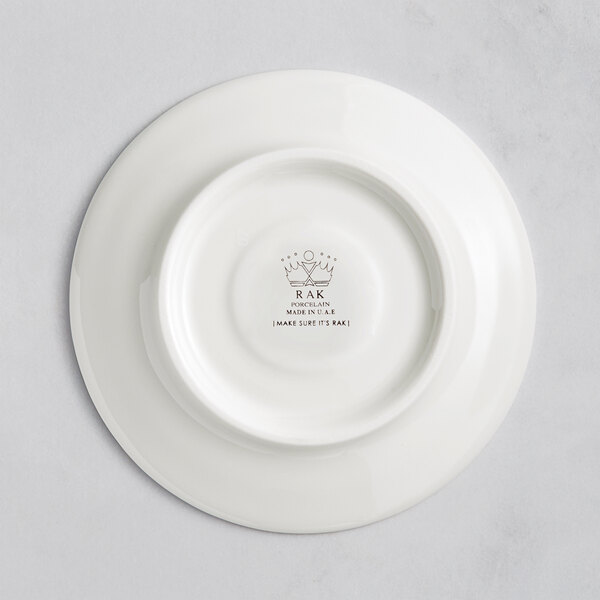 A white porcelain saucer with an embossed logo.
