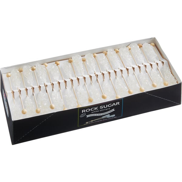 A white box of Roses Dryden and Palmer white rock candy barista stirrers.