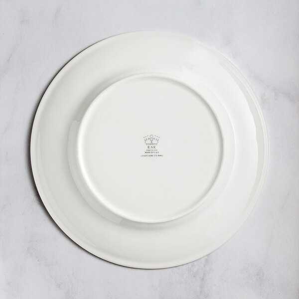 A white RAK Porcelain flat plate with an embossed floral design.