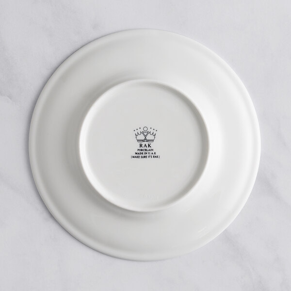 A white RAK Porcelain flat plate with an embossed floral design.