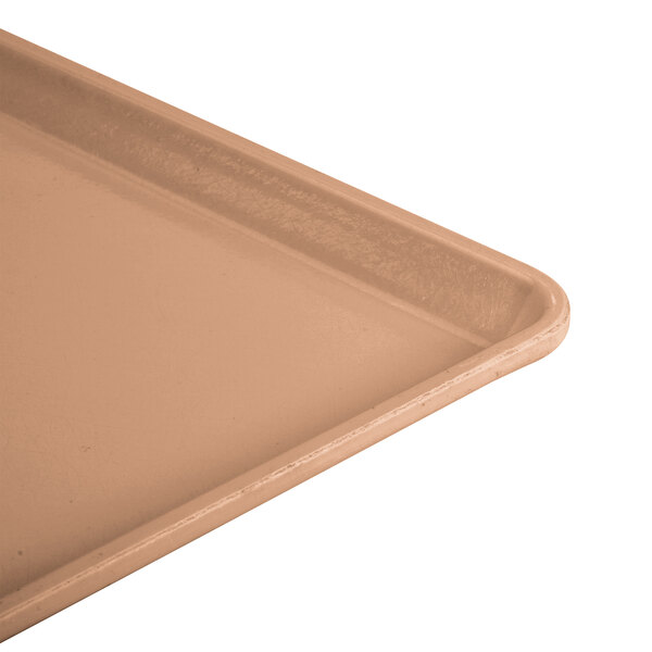 A close-up of a dark peach Cambro dietary tray.