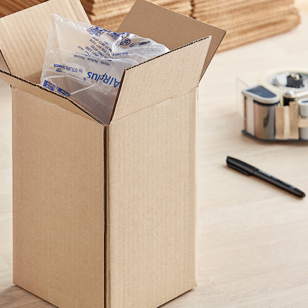 A Lavex kraft corrugated shipping box with a package inside.