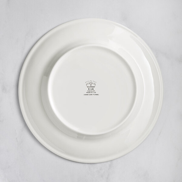 A white RAK Porcelain plate with an embossed design of flowers.