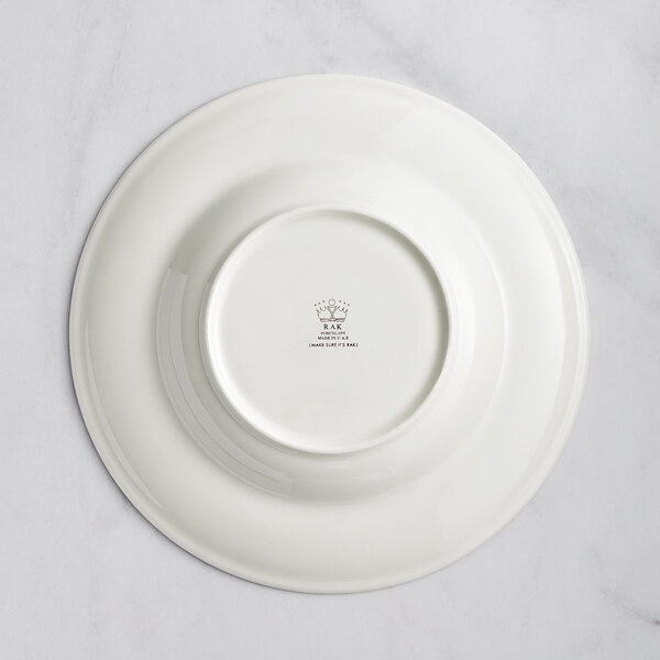A close-up of a RAK Porcelain ivory deep plate with a circular embossed design.