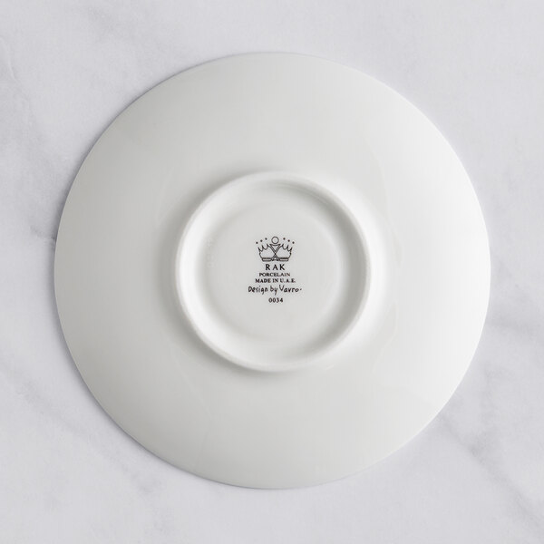 A white RAK Porcelain saucer with an ivory embossed design.