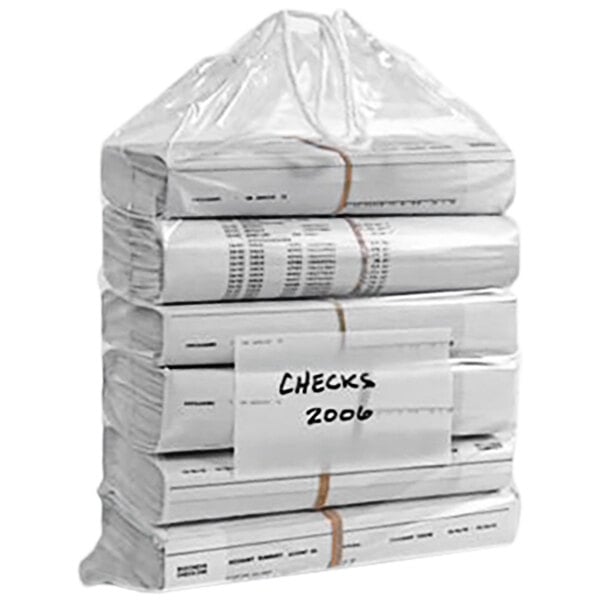A stack of newspapers in a clear plastic drawstring bag.