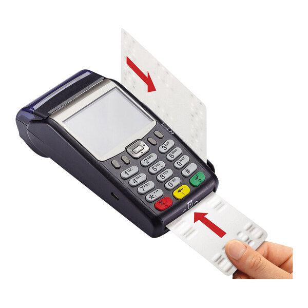 A hand is inserting a white cleaning card with red arrows into a card reader terminal.