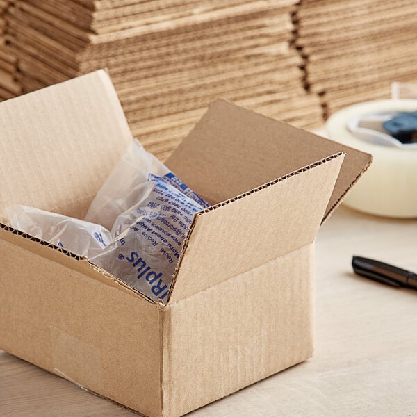 A Lavex cardboard shipping box with a pen and packaging inside.