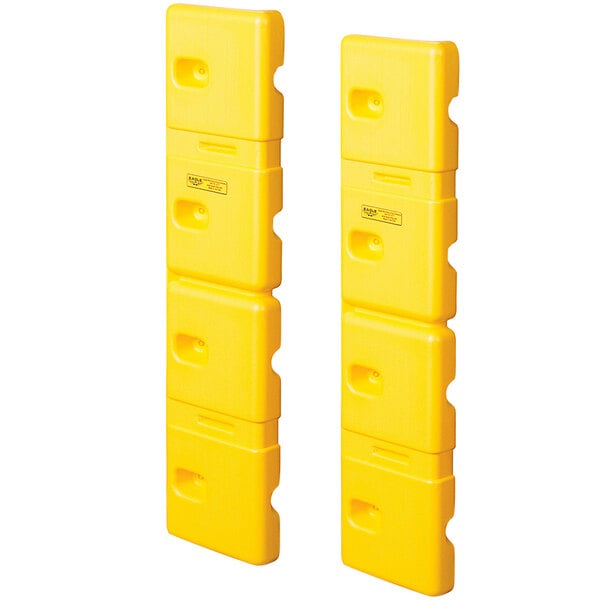 Two yellow plastic Eagle Manufacturing wall protectors with holes in them.