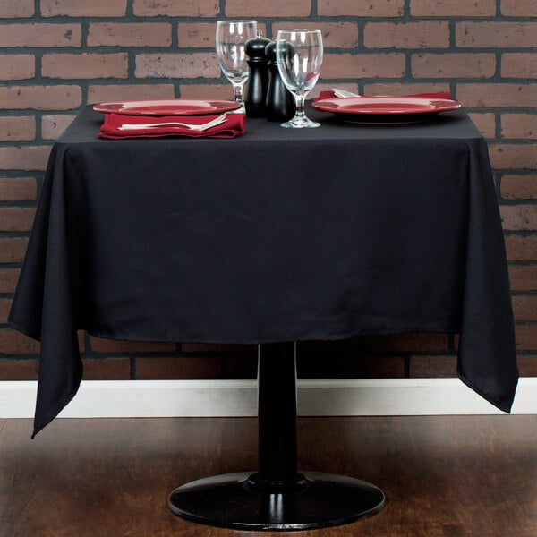 A black tablecloth on a square table