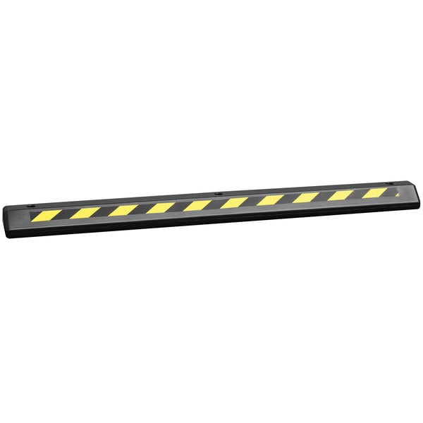 A black parking stop with yellow stripes.