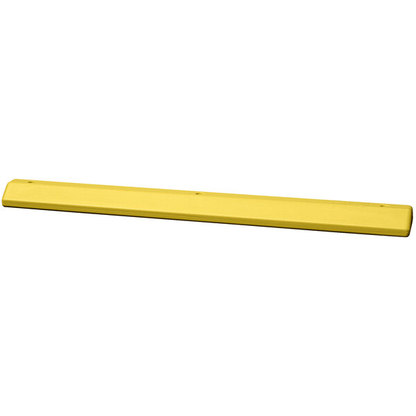 A yellow rectangular Eagle Manufacturing parking stop.