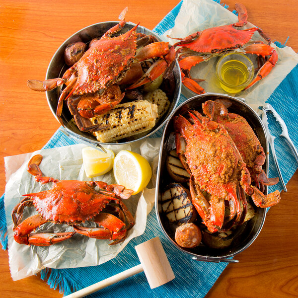 A bowl of Chesapeake Blue Crab and corn on a table with a crab and corn in a bowl.