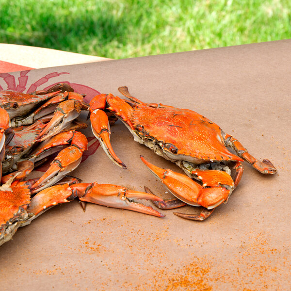 A table with a pile of Chesapeake blue crabs on it.