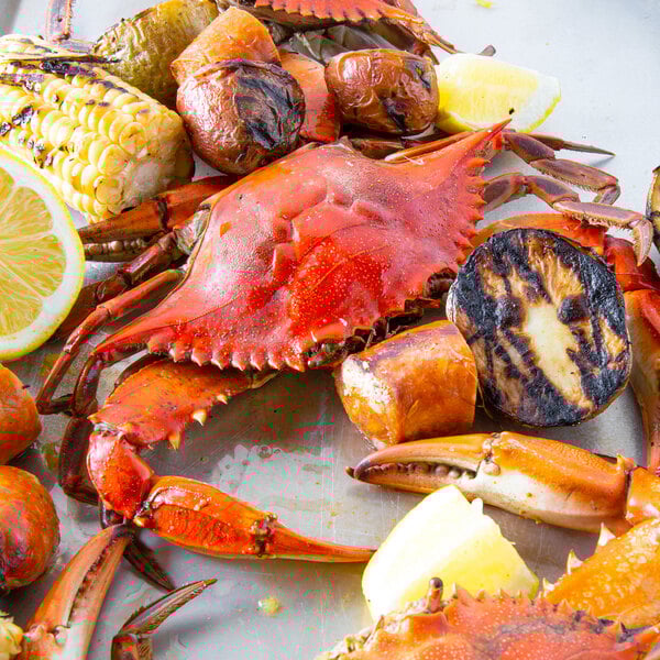 A plate with a Chesapeake Crab Connection steamed blue crab, corn on the cob, and potatoes.