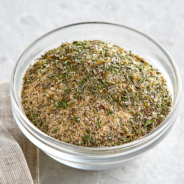 A bowl of Regal Canadian Chicken seasoning with herbs and spices.