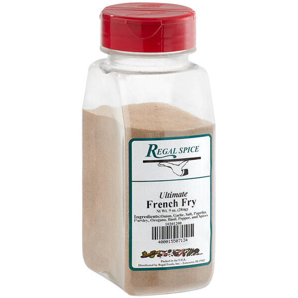 A clear container of Regal Ultimate French Fry Seasoning with a red lid.