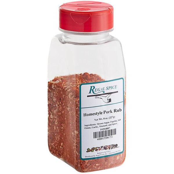 A clear container of Regal Homestyle Pork Rub seasoning with a red label and lid.