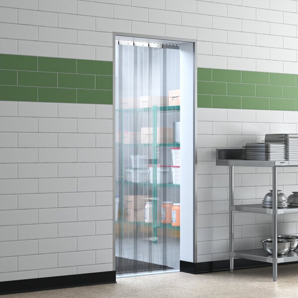 A Lavex reinforced strip door on a glass door with shelves holding boxes.