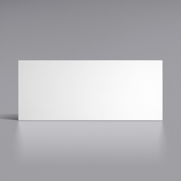 A white rectangular Lavex workbench top with a black border on a grey surface.