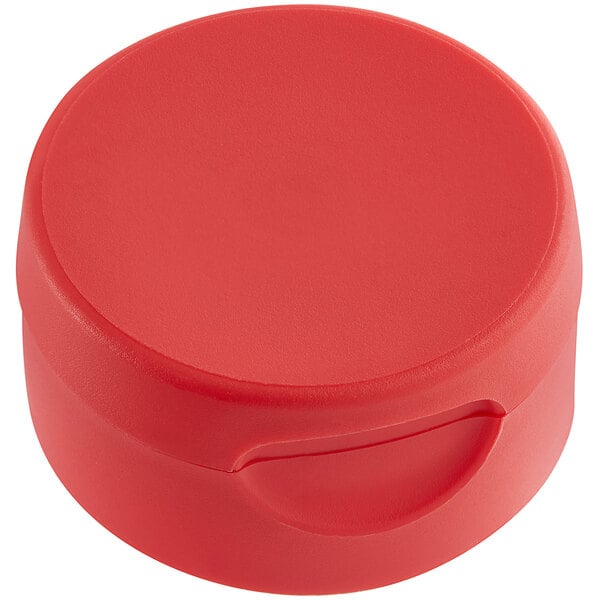 A red round container with a 38/400 red inverted squeeze bottle lid on a table.