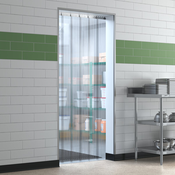 A kitchen door with a Lavex clear plastic strip curtain.