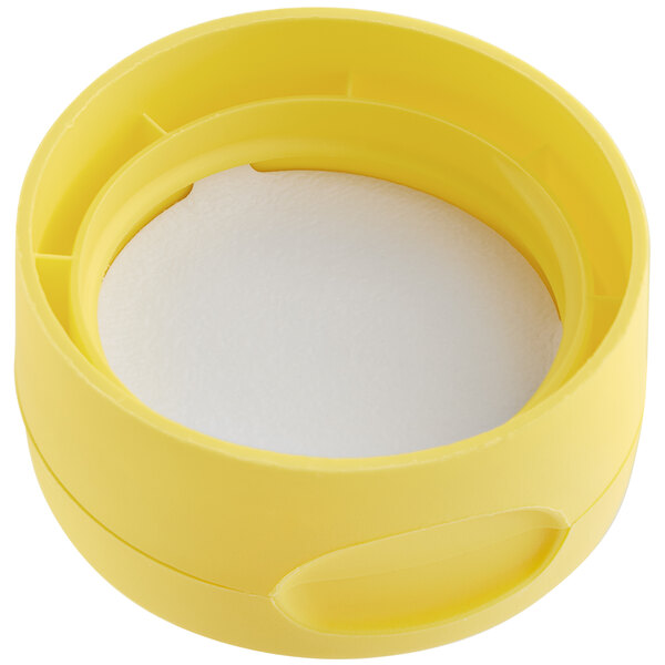 A yellow plastic lid with a white pressure sensitive liner.