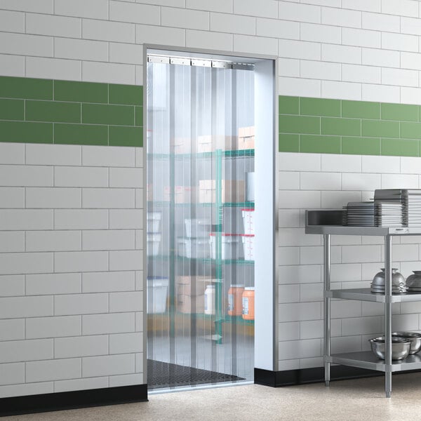 A Lavex Polar reinforced strip door hanging in a room with shelves.
