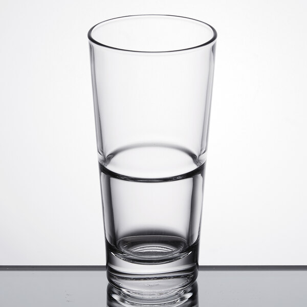 A Libbey stackable beverage glass filled with water on a table.
