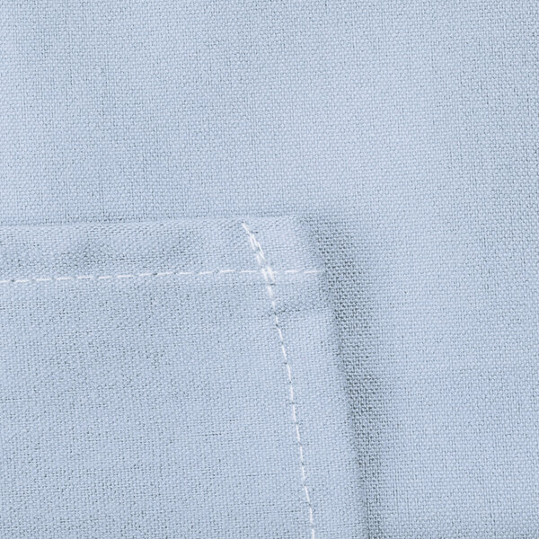 A close up of a light blue Intedge poly/cotton blend fabric square with white stitching.