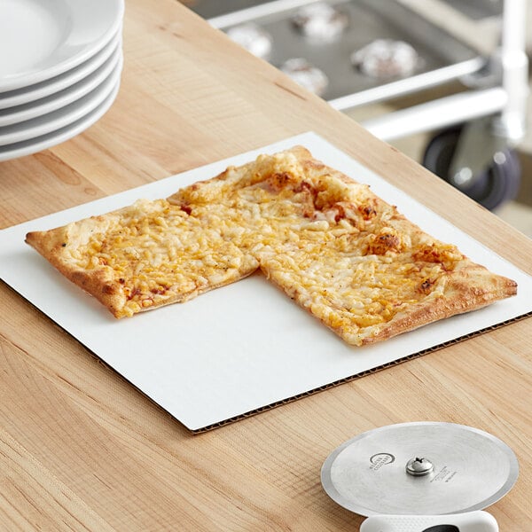 A square pizza on a white corrugated board.