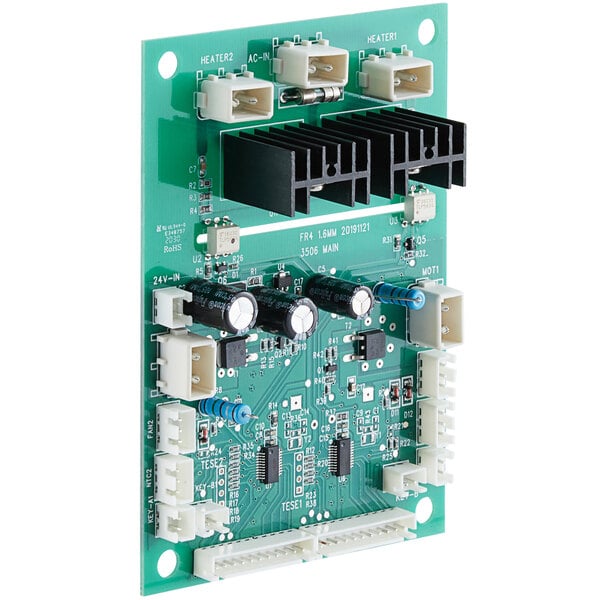 A green Carnival King control board with white and black electronic components.