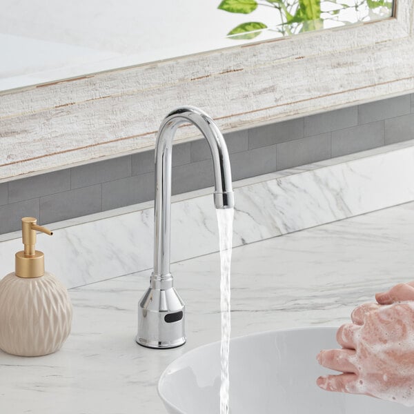 A person washing their hands under a Waterloo deck mount faucet.