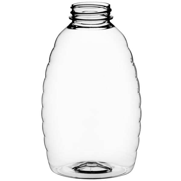 A clear plastic Classic Queenline honey bottle with a lid.