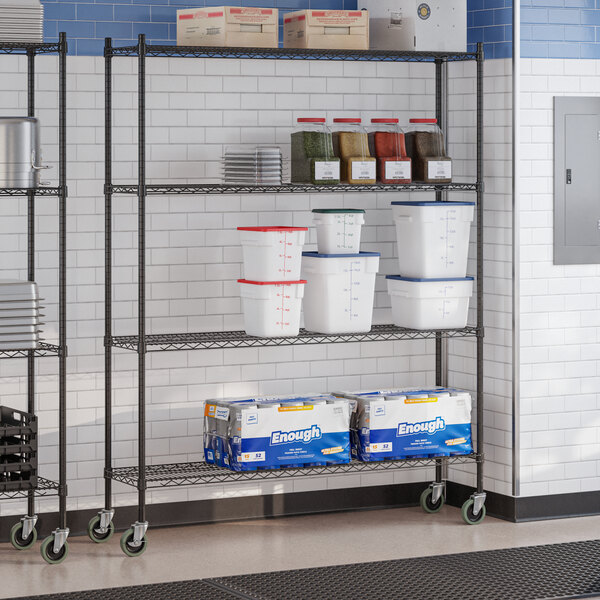 A black epoxy four-shelf wire shelving unit with casters, used for storage in commercial settings.