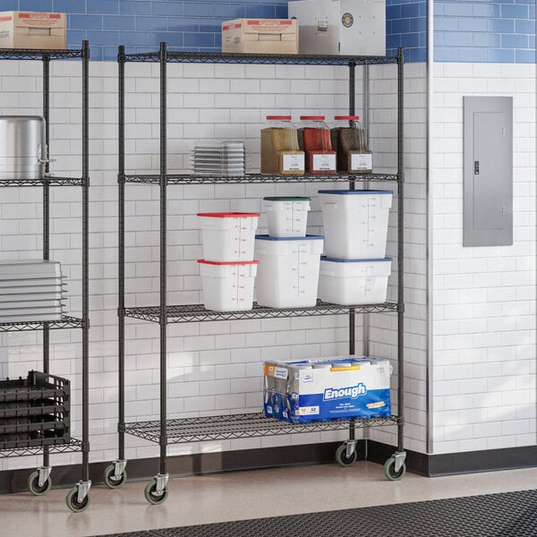 A black epoxy four-shelf wire shelving unit with casters, used for storage in commercial settings.