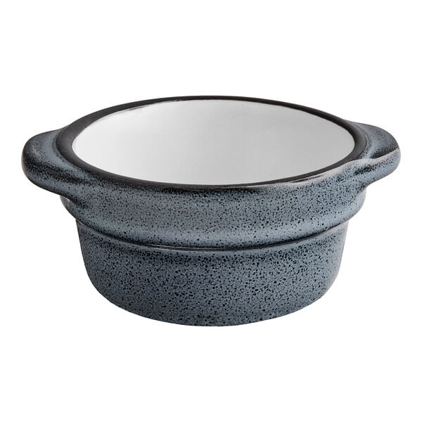 An Acopa Midnight Blue Matte stoneware sauce cup on a kitchen counter.