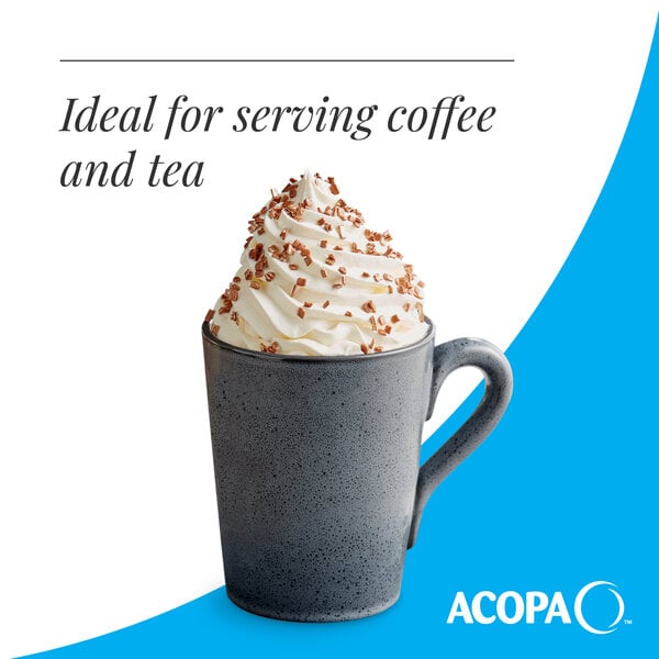 A matte midnight blue stoneware mug filled with a whipped cream-topped beverage and chocolate shavings.