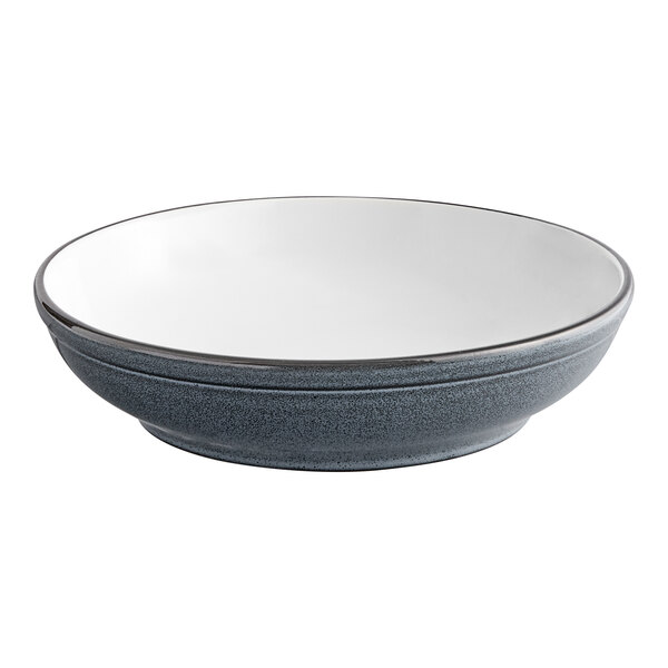 A matte blue stoneware bowl with a gray rim.