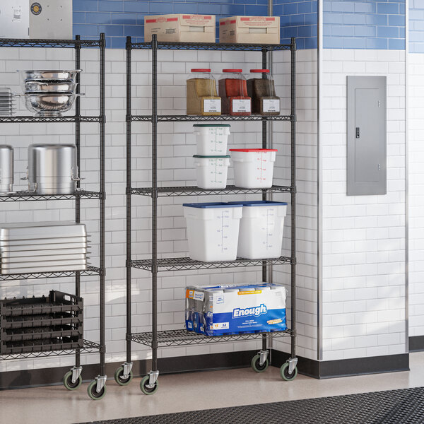 A black epoxy 5-shelf wire shelving unit with casters, used for storage in commercial settings.