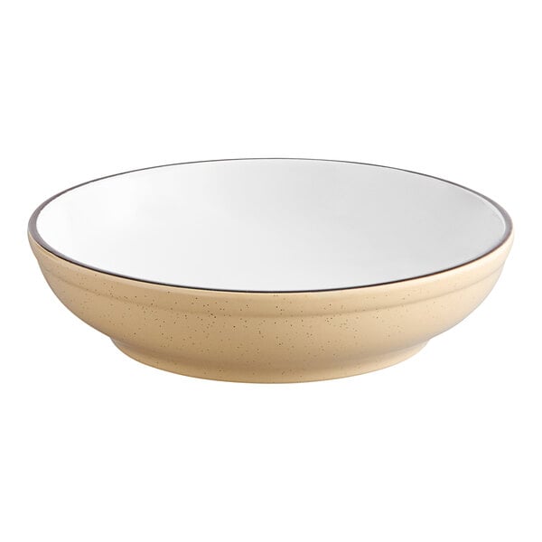 A white stoneware bowl with a tan rim.