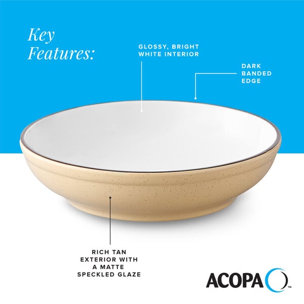 A tan matte stoneware pasta bowl with a glossy white interior and a dark banded edge.