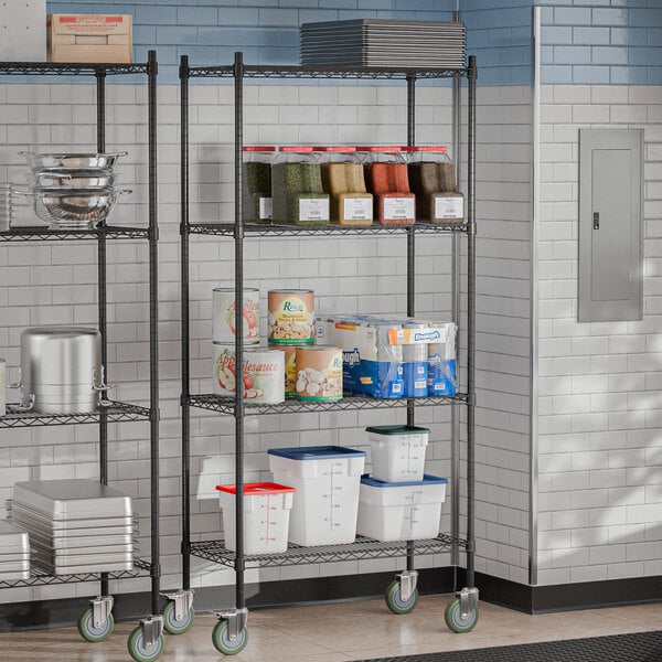 A Steelton black metal wire shelving unit with shelves and casters in a kitchen.