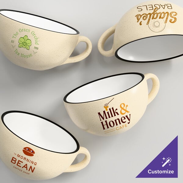 A set of cream white matte stoneware cups with various custom printed logos and designs.