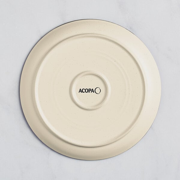 A white stoneware plate with the word "Acopa" in black text.