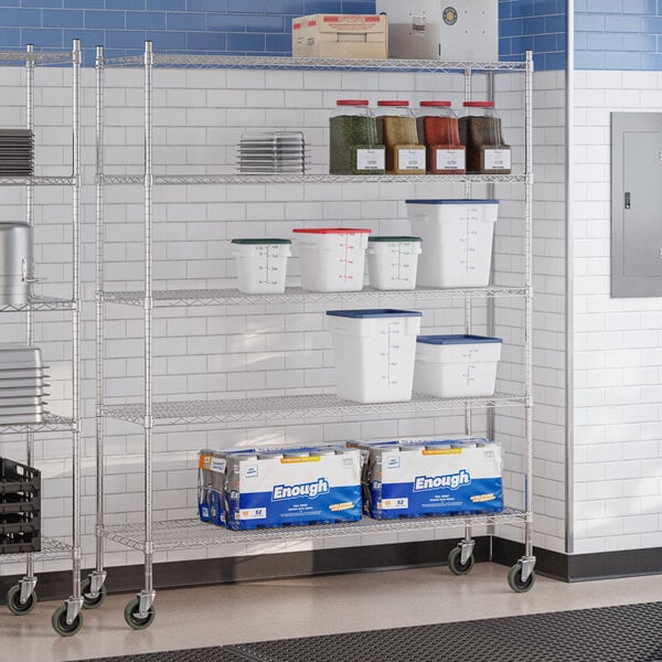A chrome 5-shelf wire shelving unit with casters, used for storage in a commercial kitchen or similar setting.