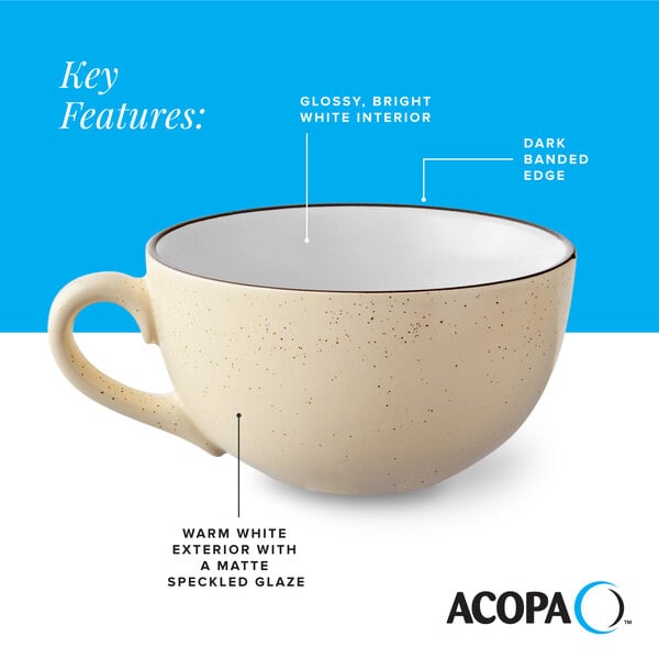 A cream white matte stoneware cup with a speckled glaze, glossy white interior, and a dark banded edge.